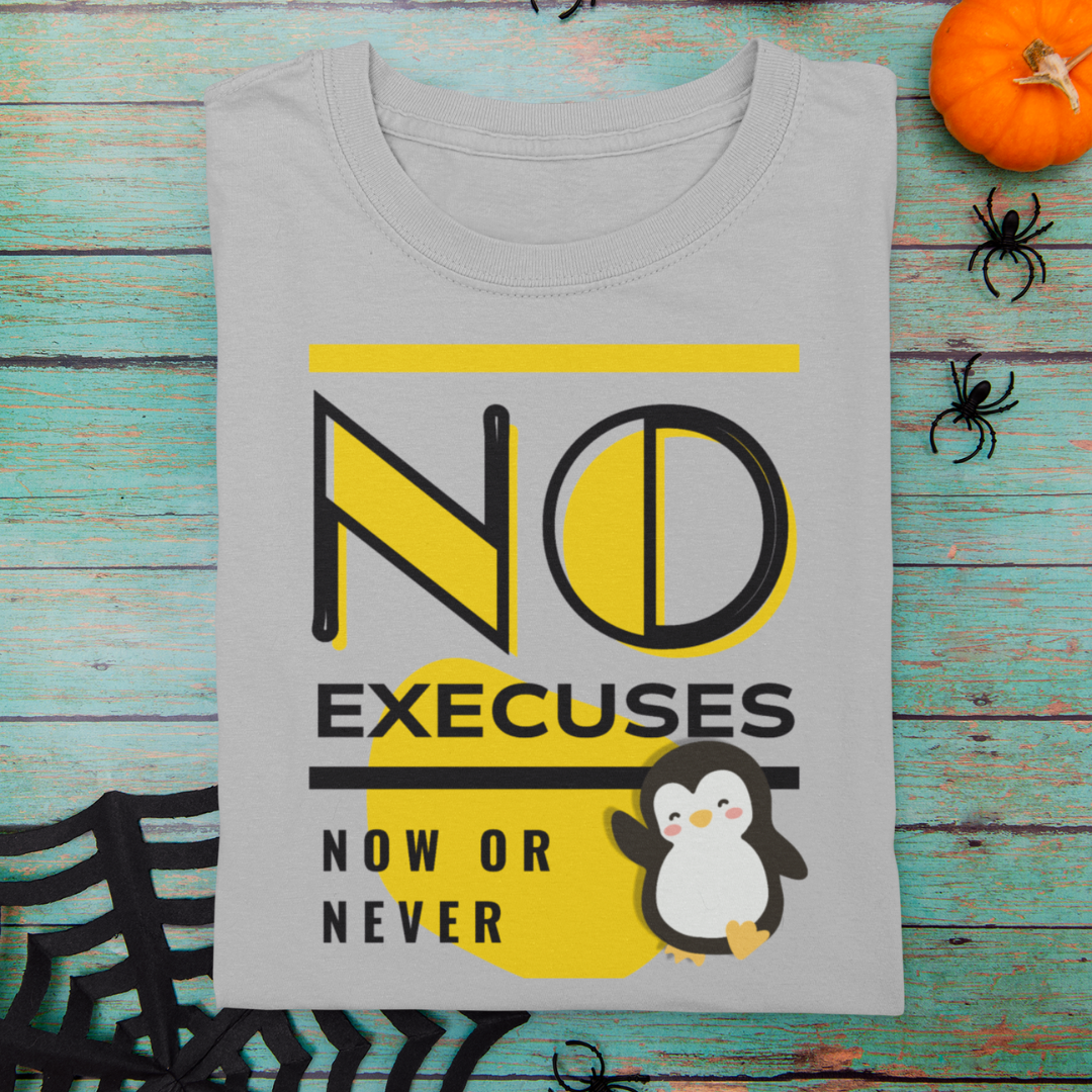 Gray t-shirt with a penguin graphic and text on a wooden surface with Halloween decorations.