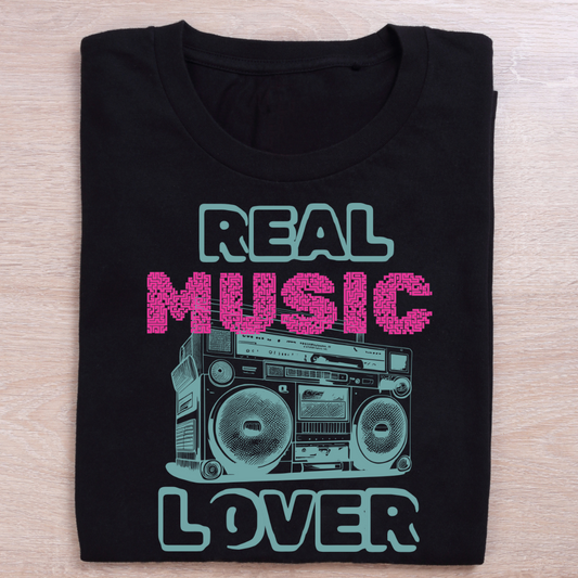 Black t-shirt with 'Real Music Lover' graphic design on a wooden surface