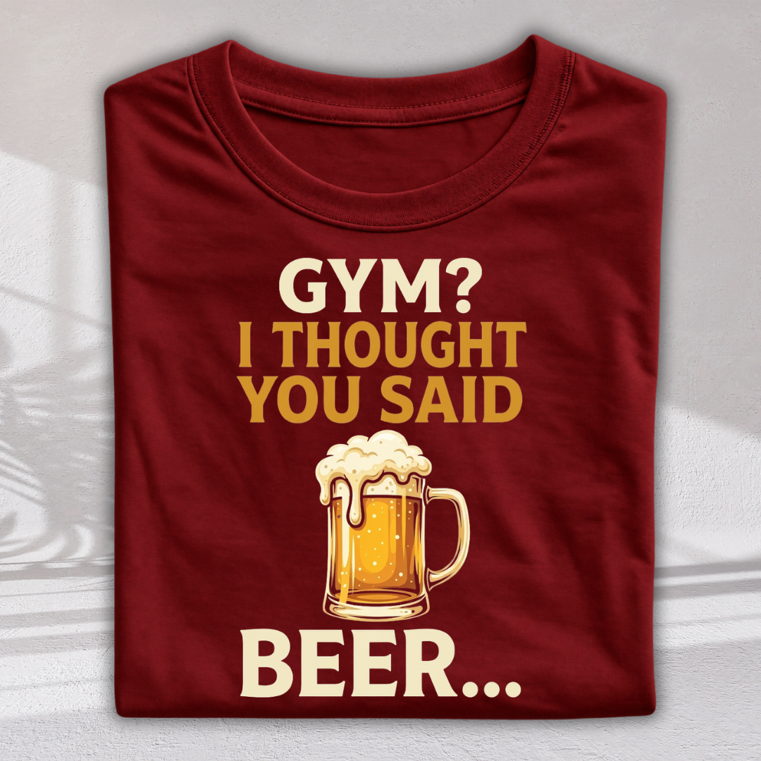 A folded maroon crewneck t-shirt with a graphic print that reads 'GYM? I THOUGHT YOU SAID BEER.