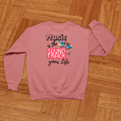 Coral sweatshirt with motivational text on a wooden floor