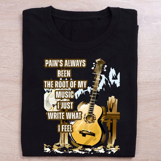 Black t-shirt with guitar graphic and text on a wooden surface
