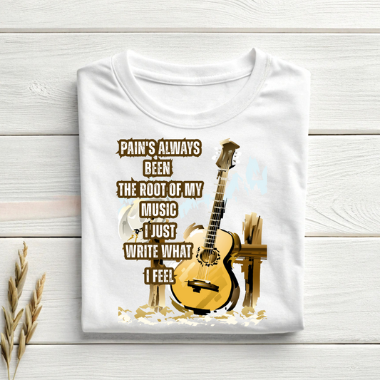 White t-shirt with guitar graphic and text on a wooden surface