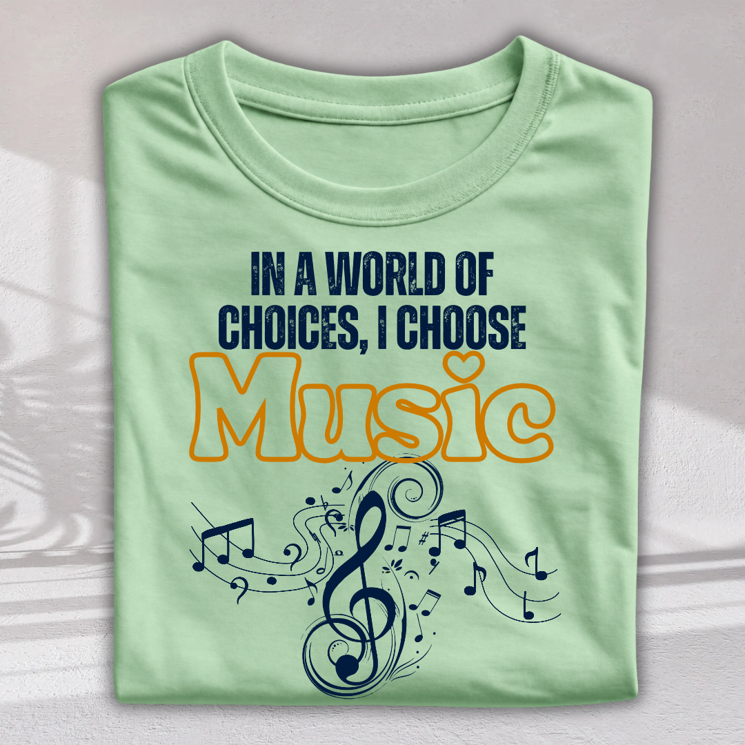 A folded light green t-shirt with a graphic print that reads 'IN A WORLD OF CHOICES, I CHOOSE Music' in navy blue and orange, decorated with a musical treble clef and notes.
