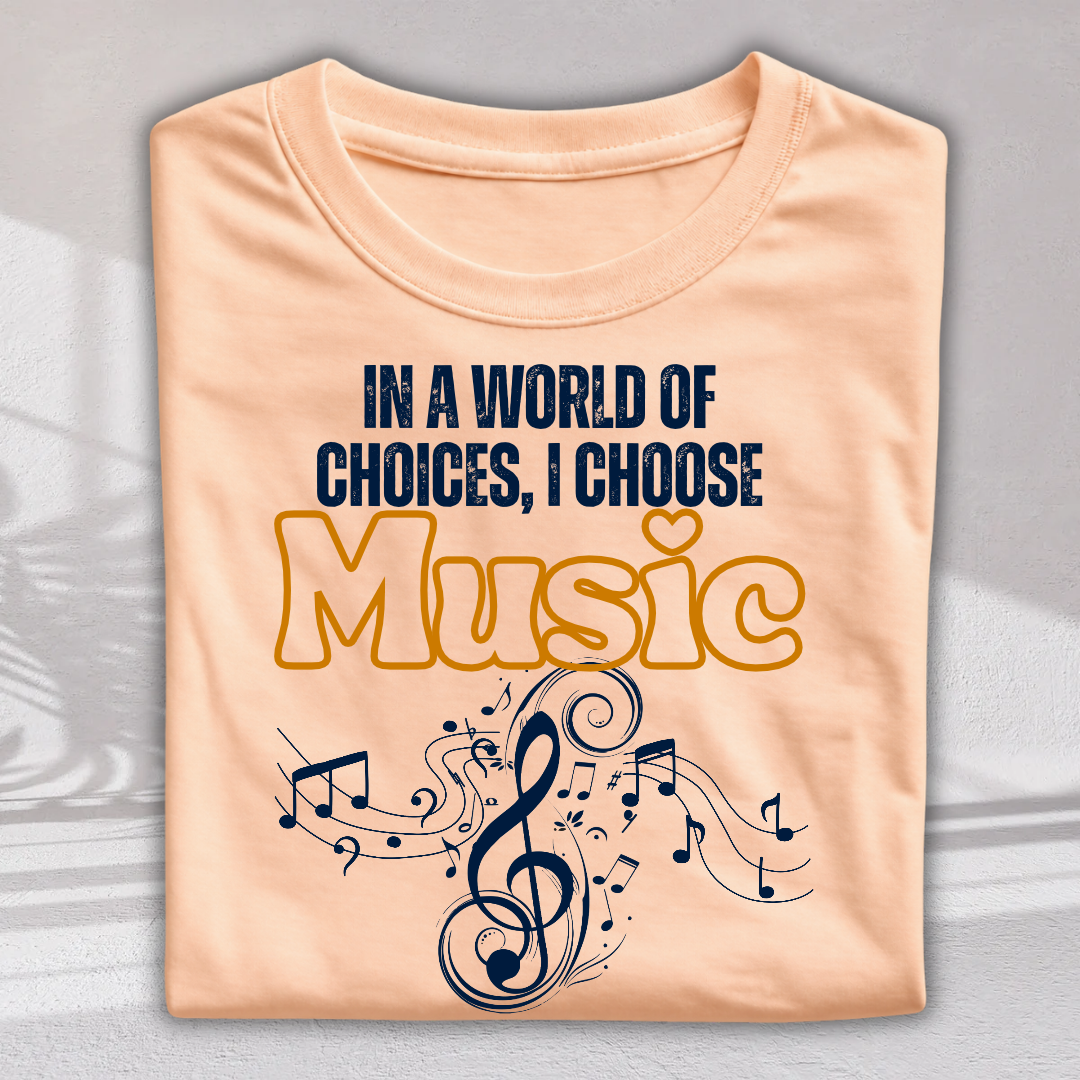 A peach-colored t-shirt with a graphic print that reads 'IN A WORLD OF CHOICES, I CHOOSE Music' in navy blue and yellow, featuring musical notes and a treble clef, shown on a light gray background.