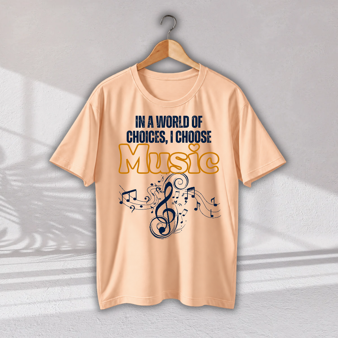 A peach-colored short-sleeve t-shirt hanging on a wooden hanger against a light gray wall. The shirt features a graphic print with the text 'IN A WORLD OF CHOICES, I CHOOSE Music' in navy blue and yellow, accompanied by a musical treble clef and notes.