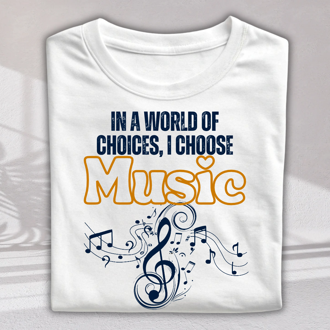 A folded white t-shirt with a graphic print that reads 'IN A WORLD OF CHOICES, I CHOOSE Music' in navy blue and orange lettering, decorated with a navy blue musical treble clef and notes, shown on a light gray background.