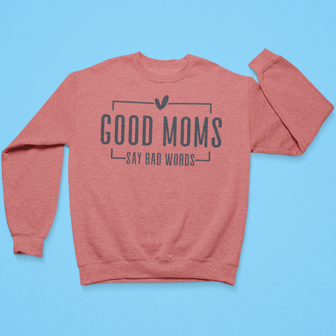 Coral sweatshirt with 'Good moms say bad words' text on a blue background