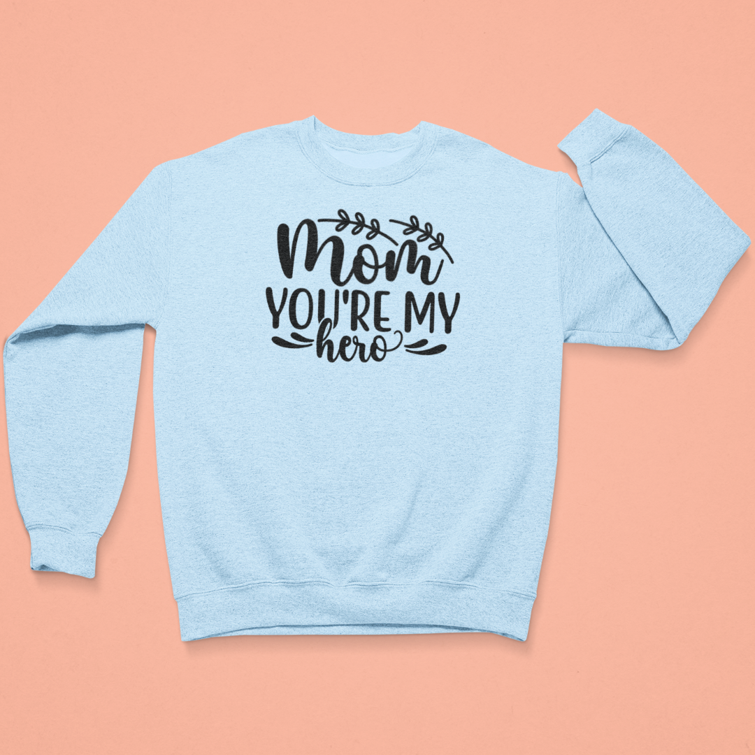 Light blue sweatshirt with 'Mom, you're my hero' text on a peach background