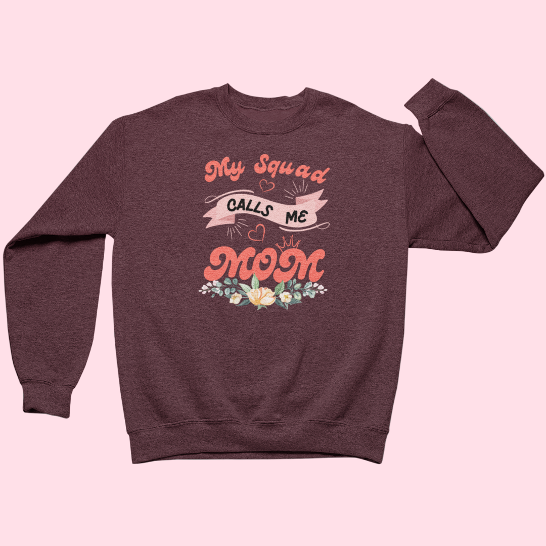 Maroon sweatshirt with 'My Squad Calls Me Mom' text on a pink background