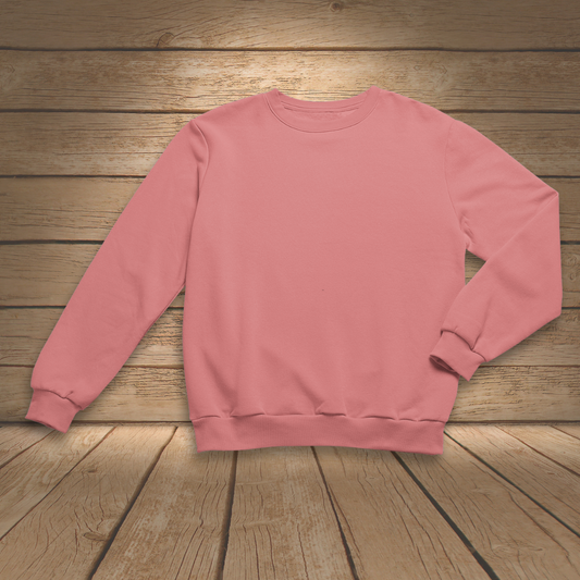 Coral sweatshirt on a wooden surface