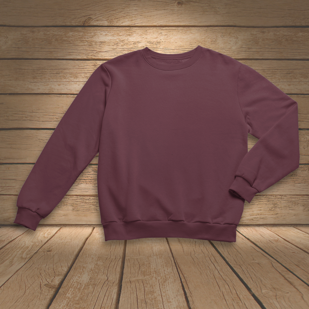 Maroon sweatshirt on a wooden surface
