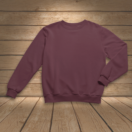 Maroon sweatshirt on a wooden surface