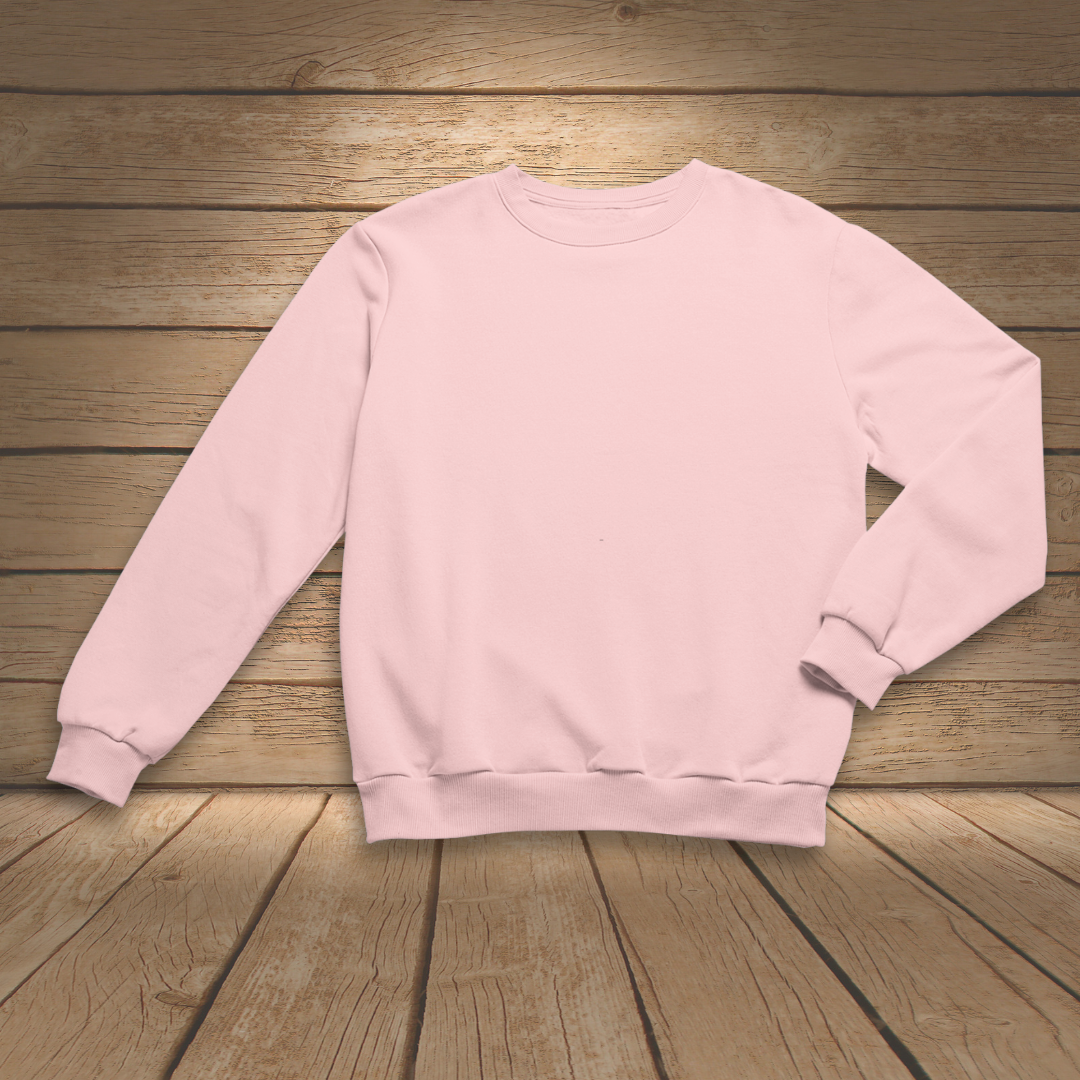 Pink sweatshirt on a wooden surface