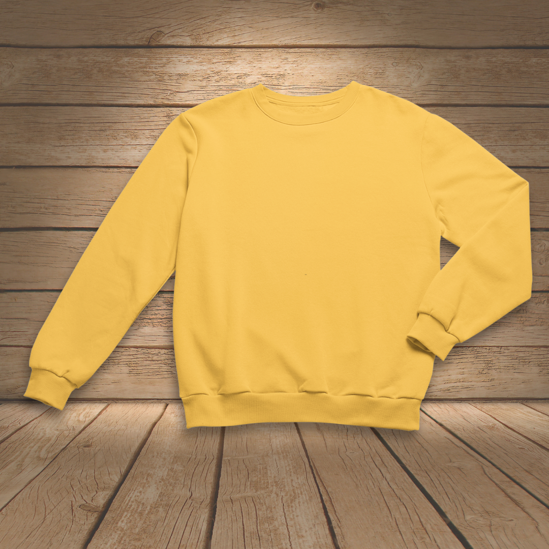 Mustard Yellow sweatshirt on a wooden surface